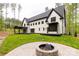 Backyard with a brick fire pit in front of a home with a covered porch at 3268 Sherman Dr, Lancaster, SC 29720
