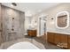 A modern bathroom featuring marble tile, a walk-in shower, double vanity, and barn door access to the walk-in closet at 3268 Sherman Dr, Lancaster, SC 29720
