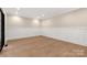 An empty bedroom showcasing wood flooring, recessed lighting, wainscotting and an oversized dark-framed window at 3268 Sherman Dr, Lancaster, SC 29720
