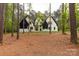 Stunning two-story home featuring white brick, black trim, and a well-manicured lawn surrounded by lush trees at 3268 Sherman Dr, Lancaster, SC 29720