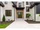 Stunning front entrance with a black metal door and wooden beam accents at 3268 Sherman Dr, Lancaster, SC 29720