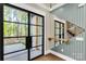Hallway with modern mirror, view to staircase and sliding doors to patio at 3268 Sherman Dr, Lancaster, SC 29720