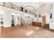 Expansive open concept space with a modern kitchen, grand staircase, and loft access at 3268 Sherman Dr, Lancaster, SC 29720