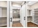 Walk-in closet with hanging racks, shelves and an attached bathroom at 3268 Sherman Dr, Lancaster, SC 29720