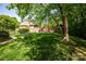 Large, well-manicured lawn with a brick privacy fence and mature trees at 3622 Roxburgh Ln, Gastonia, NC 28056