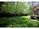 Lush backyard with manicured lawn, mature trees, and elegant landscaping at 3622 Roxburgh Ln, Gastonia, NC 28056