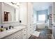 Bright bathroom featuring dual sink vanity, storage cabinets, and a luxurious soaking tub, creating a spa-like experience at 3622 Roxburgh Ln, Gastonia, NC 28056