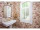 Charming powder room with floral wallpaper, pedestal sink, and natural light at 3622 Roxburgh Ln, Gastonia, NC 28056