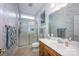 A well-lit bathroom with a glass-enclosed shower, single sink vanity, and decorative wallpaper, offering a fresh and clean space at 3622 Roxburgh Ln, Gastonia, NC 28056