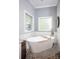 This elegant bathroom is equipped with a freestanding tub and tiled floor, offering a serene and spa-like experience at 3622 Roxburgh Ln, Gastonia, NC 28056