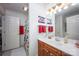 A clean bathroom featuring a single sink vanity and a shower with Coca-Cola-themed shower curtain for a distinctive touch at 3622 Roxburgh Ln, Gastonia, NC 28056