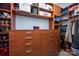 A well-organized walk-in closet with custom wood shelves and drawers to maximize storage and add a touch of elegance at 3622 Roxburgh Ln, Gastonia, NC 28056