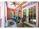 Covered brick patio with comfortable seating, ceiling fan, and access to the house via French doors at 3622 Roxburgh Ln, Gastonia, NC 28056