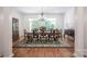 Sun-filled dining room with hardwood floors, large windows, and classic chandelier at 3622 Roxburgh Ln, Gastonia, NC 28056