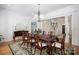 Elegant dining room with hardwood floors, staircase view, and chandelier at 3622 Roxburgh Ln, Gastonia, NC 28056