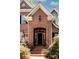 Welcoming brick entry with arched doorway, custom door, and manicured landscaping at 3622 Roxburgh Ln, Gastonia, NC 28056