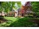 Charming brick home with lush green lawn, mature trees, and colorful landscaping at 3622 Roxburgh Ln, Gastonia, NC 28056
