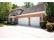 Spacious three-car garage with white doors and brick exterior at 3622 Roxburgh Ln, Gastonia, NC 28056
