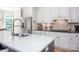 A modern kitchen with white cabinets, stainless steel appliances, and a large island with a white countertop at 3622 Roxburgh Ln, Gastonia, NC 28056