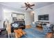Comfortable living room featuring hardwood floors, a stone fireplace, and open access to the kitchen at 3622 Roxburgh Ln, Gastonia, NC 28056