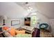 Attic living area with a decorative fireplace, large window, a comfortable couch and accent chair at 3622 Roxburgh Ln, Gastonia, NC 28056