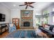 Cozy living room with a stone fireplace, hardwood floors, and comfortable seating at 3622 Roxburgh Ln, Gastonia, NC 28056