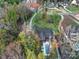 An aerial view of a home with a pool, well-manicured lawn, and a winding driveway at 4071 Poplar Ridge Dr, Fort Mill, SC 29715
