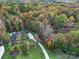 Aerial view of a home surrounded by colorful trees and a lush green yard at 4071 Poplar Ridge Dr, Fort Mill, SC 29715