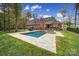 A beautiful brick home backyard features a swimming pool, and travertine tile at 4071 Poplar Ridge Dr, Fort Mill, SC 29715