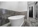 Bathroom featuring a modern freestanding tub and tile accent wall at 4071 Poplar Ridge Dr, Fort Mill, SC 29715