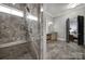 A luxurious bathroom with a walk-in shower featuring marble tile and a built-in bench at 4071 Poplar Ridge Dr, Fort Mill, SC 29715