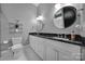 Stylish bathroom featuring double sinks, black countertops, and a black and white tiled floor at 4071 Poplar Ridge Dr, Fort Mill, SC 29715