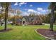 A stunning, stately brick home features lush front lawn and meticulous landscaping at 4071 Poplar Ridge Dr, Fort Mill, SC 29715