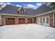 Spacious three-car garage with brick facade and carriage-style doors at 4071 Poplar Ridge Dr, Fort Mill, SC 29715
