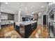 Open concept kitchen features an island with seating, stainless steel appliances, and seamless flow to dining area at 4071 Poplar Ridge Dr, Fort Mill, SC 29715