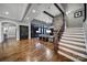 Bright living room showcases a stone fireplace, staircase, hardwood floors, and seamlessly connected spaces at 4071 Poplar Ridge Dr, Fort Mill, SC 29715
