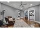 Comfortable living room with leather chair, ceiling fan, and view to bathroom with granite counters at 4071 Poplar Ridge Dr, Fort Mill, SC 29715