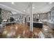 Spacious living room with hardwood floors, stone fireplace, and modern kitchen island at 4071 Poplar Ridge Dr, Fort Mill, SC 29715