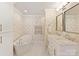 Spa-like bathroom with a soaking tub, double vanity, and elegant fixtures, and heated towel rack at 4407 Coventry Row Ct, Charlotte, NC 28270