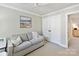 A bright room featuring a neutral-toned sofa, creating a relaxing and comfortable space at 4407 Coventry Row Ct, Charlotte, NC 28270