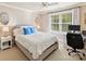 Comfortable bedroom featuring a plush bed, ceiling fan, and a window overlooking the yard at 4407 Coventry Row Ct, Charlotte, NC 28270