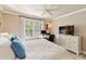 A cozy bedroom boasts a comfortable bed with a large window offering natural light at 4407 Coventry Row Ct, Charlotte, NC 28270
