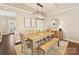Cozy dining area featuring a wooden table with seating for six, modern light fixture, and hardwood floors at 4407 Coventry Row Ct, Charlotte, NC 28270