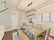 Cozy dining area featuring a wooden table with seating for six, modern light fixture, and hardwood floors at 4407 Coventry Row Ct, Charlotte, NC 28270