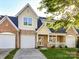 Charming two-story home with a brick and siding exterior, a well-manicured lawn, and attached two-car garage at 4407 Coventry Row Ct, Charlotte, NC 28270