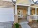 Inviting front porch featuring brick columns, white railing, and double front doors for a warm welcome at 4407 Coventry Row Ct, Charlotte, NC 28270