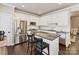 Modern kitchen features stainless steel appliances, an island with bar seating, and white cabinetry at 4407 Coventry Row Ct, Charlotte, NC 28270
