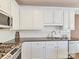 Modern kitchen design with stainless steel appliances, white cabinets, and a subway tile backsplash at 4407 Coventry Row Ct, Charlotte, NC 28270