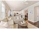 Bright living room with plush seating, hardwood floors, and an open flow to the kitchen and dining area at 4407 Coventry Row Ct, Charlotte, NC 28270