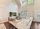 Bright and airy living room features a soaring ceiling, hardwood floors, and a comfortable seating area at 4407 Coventry Row Ct, Charlotte, NC 28270